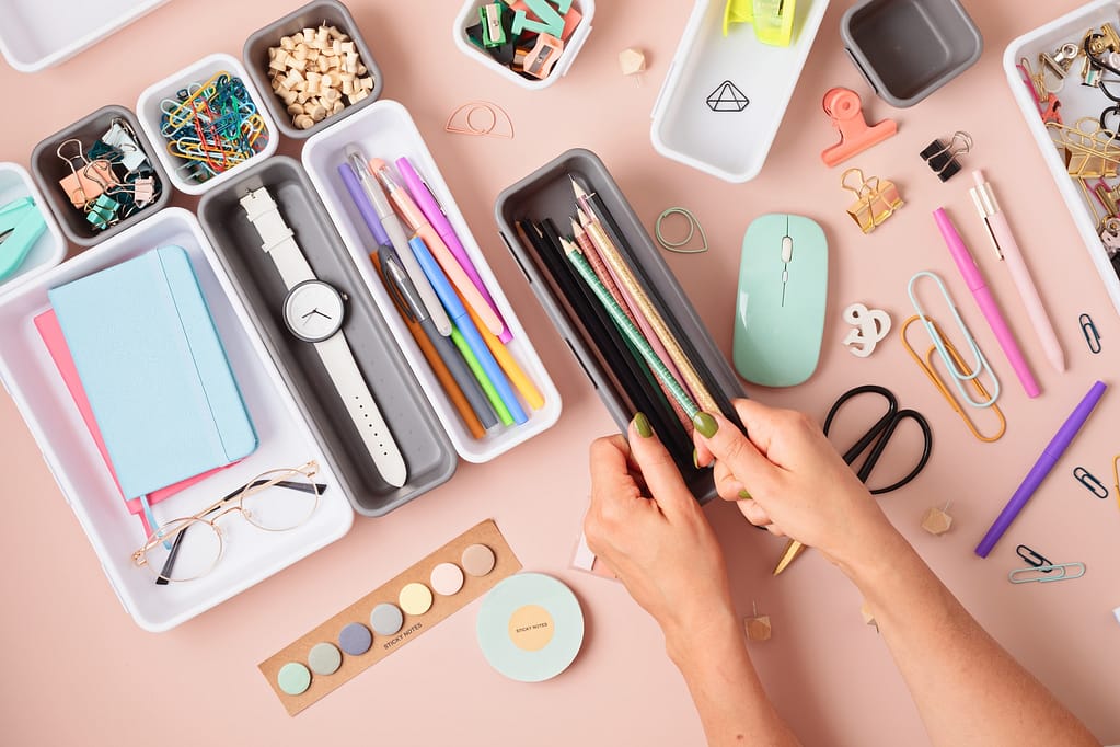 Desktop organization. Cleaning up messy stationary in plastic organizers
