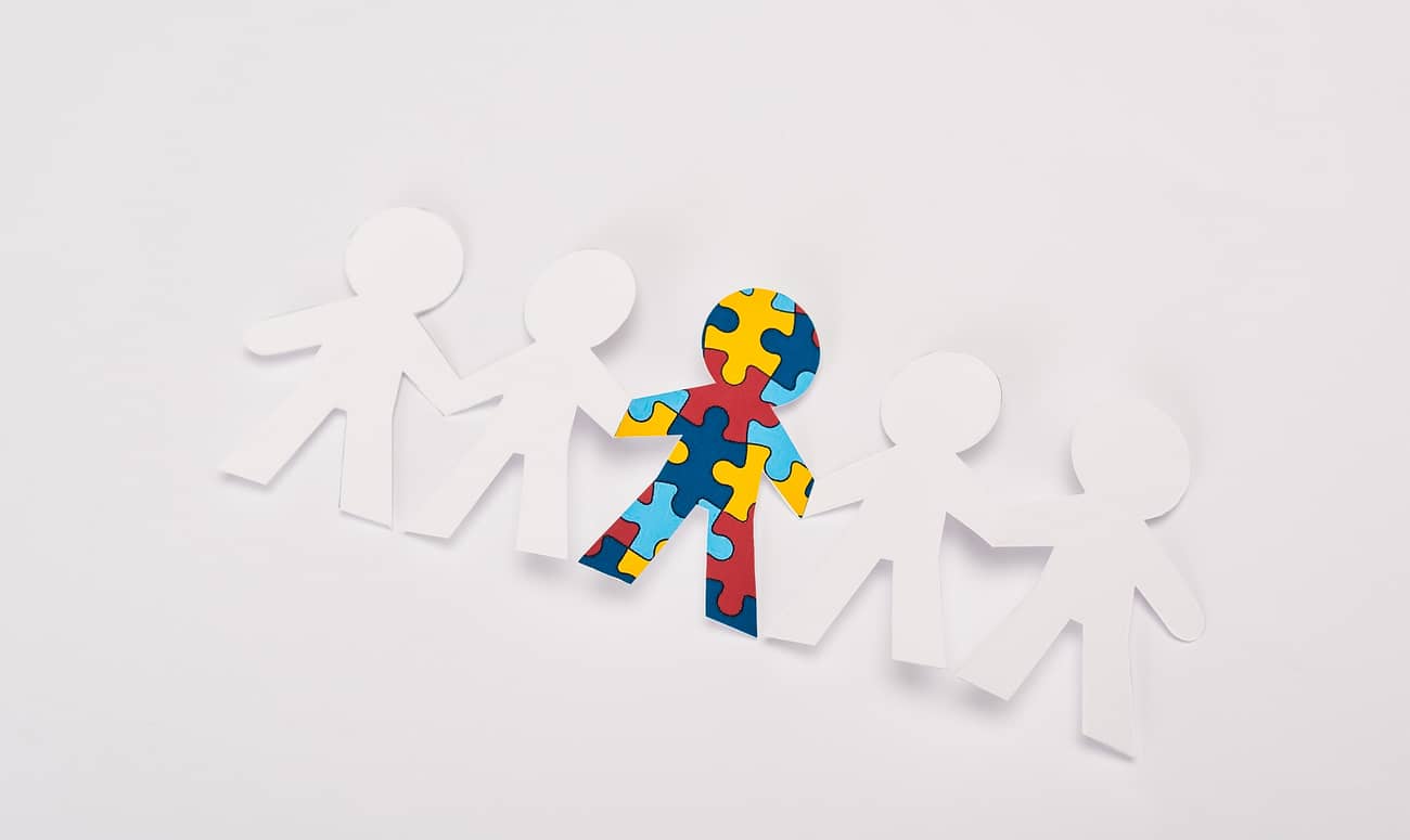 High angle view of special kid with autism among another on white background