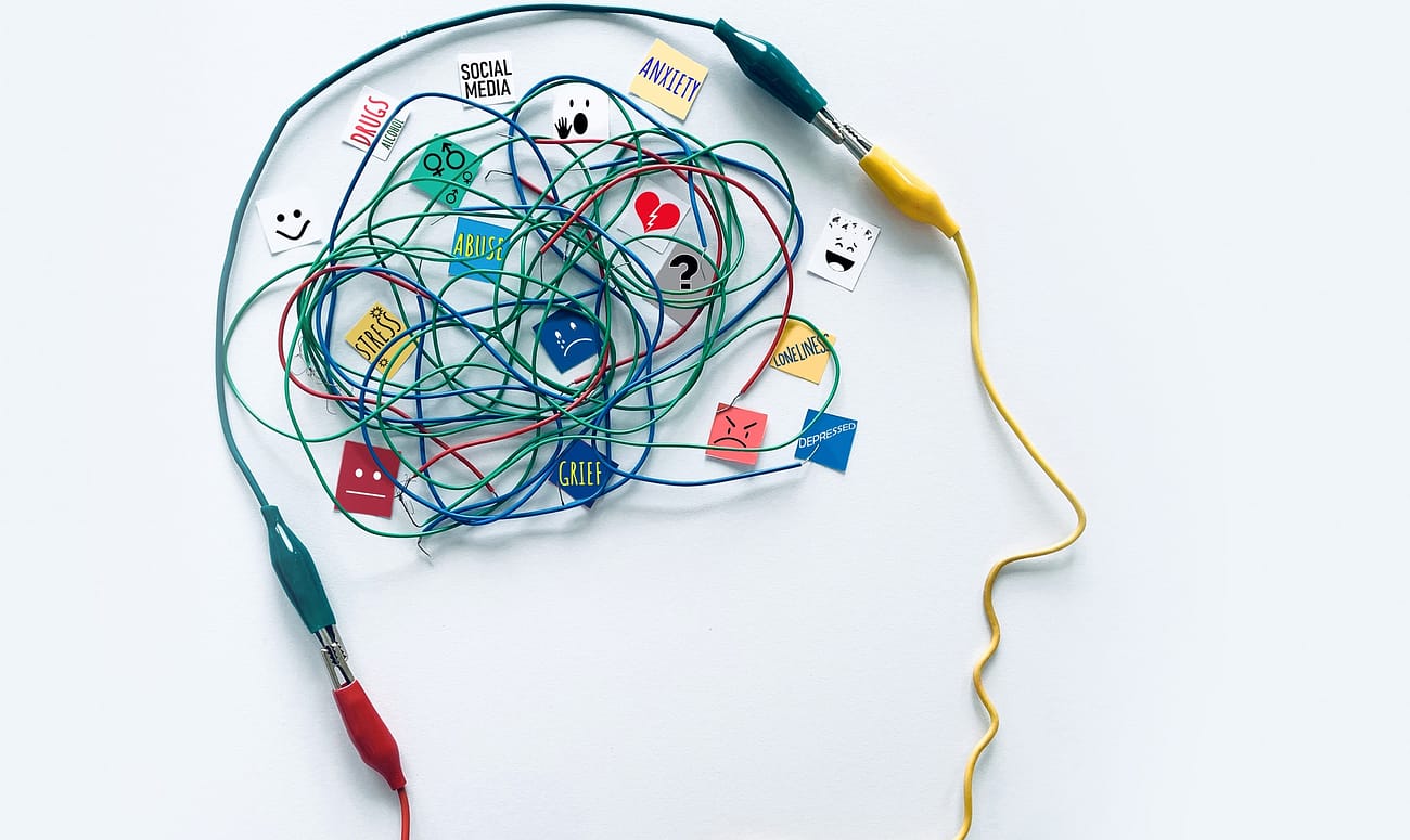 Mental Health concept with many of the factors that can affect the brain triggering mental illness