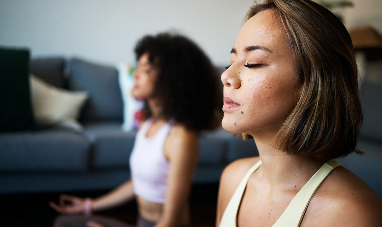 Women, fitness friends and meditation with mindfulness, wellness and peace of mind with breathing a